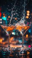 Two martini glasses clinking together with splashes in a dimly lit bar setting at night photo