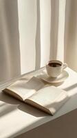 A cozy reading corner with an open book and a cup of coffee in soft morning light photo