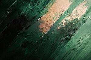 Textured green and gold surface with abstract patterns created through paint photo