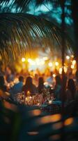 A summer evening gathering with warm lights in a tropical setting surrounded by lush greenery photo