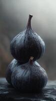 Fresh black figs stacked elegantly with water droplets on a dark surface in soft lighting photo