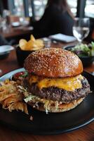 Delicious cheeseburger served with fresh salad and sides at a cozy restaurant during dinner time photo