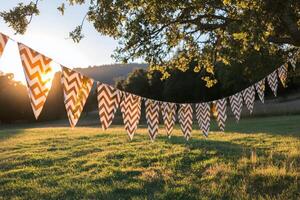 Colorful decorative flags hanging from a tree in a sunny garden during late afternoon photo
