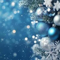 Beautiful blue and silver ornaments hanging on a Christmas tree with a winter background photo