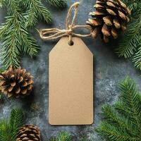 Blank tag surrounded by pine cones and evergreen branches for holiday decoration photo