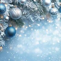 Beautiful blue and silver ornaments hanging on a Christmas tree with a winter background photo