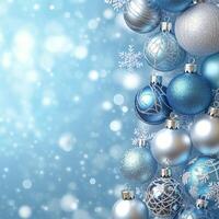 Beautiful blue and silver ornaments hanging on a Christmas tree with a winter background photo