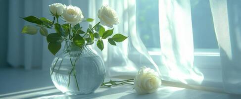 Fresh peach roses arranged in a glass vase by a sunlit window in a cozy indoor setting photo