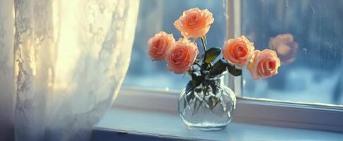 Fresh peach roses arranged in a glass vase by a sunlit window in a cozy indoor setting photo