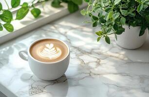 A cozy cup of latte art placed on a book next to indoor plants in a serene setting photo