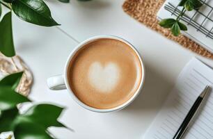 A cozy cup of latte art placed on a book next to indoor plants in a serene setting photo