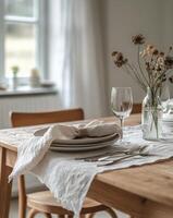 Setting a beautiful dining table with elegant cutlery and minimalistic decor in a cozy atmosphere photo