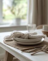 Setting a beautiful dining table with elegant cutlery and minimalistic decor in a cozy atmosphere photo