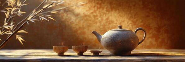 Traditional tea set arranged on bamboo table with warm lighting highlighting the scene photo