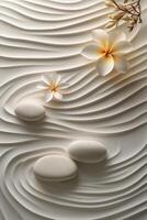 Tranquil arrangement of stones and flowers on textured sand pattern in a serene setting photo