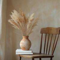 A rustic vase filled with dried pampas grass stands beside an old wooden chair in a cozy room photo