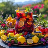 Refreshing summer fruit punch served in a glass pitcher with lemons and berries on a colorful table photo