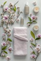 Elegant spa arrangement with towels, candles, and floral decorations set on a soft backdrop photo