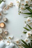 Elegant spa arrangement with towels, candles, and floral decorations set on a soft backdrop photo