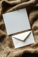 Minimalist blank card and envelope on textured fabric background for creative design projects photo