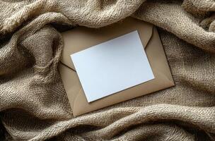 Blank card resting on textured burlap fabric creates a simple and rustic background composition photo