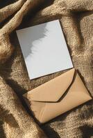 Minimalist blank card and envelope on textured fabric background for creative design projects photo