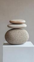 Elegant stone arrangement on a white pedestal showcasing minimalist design and natural textures photo