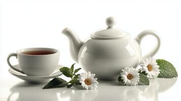 A tranquil tea setup with a teapot, cup, and fresh daisies arranged in a peaceful setting photo