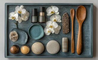 Elegant white orchids and spa products arranged on a soft blue surface for relaxation and beauty photo