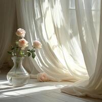 Soft morning light illuminates pink roses in a vase near sheer curtains by a window photo