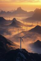 Dramatic sunset over wind turbines in a mountainous landscape shrouded in mist photo