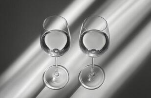 Elegant crystal glasses on a white surface with soft lighting during the afternoon photo