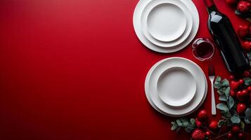 Elegant dining setup with wine glasses, plates, and a bottle against a rich red background photo