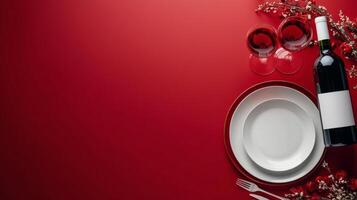 Elegant dining setup with wine glasses, plates, and a bottle against a rich red background photo