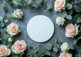 Elegant arrangement of light pink roses and greenery surrounding a blank circular canvas photo