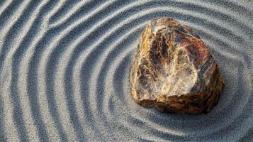 A Single Rock Resting on a Pattern of Ripples in Sand photo
