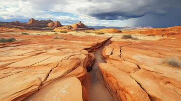 A Crack in the Desert Landscape with Sandstone Formations and Dramatic Clouds photo