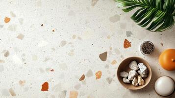 Terrazzo Surface with Stones, Palm Leaf, and Objects photo