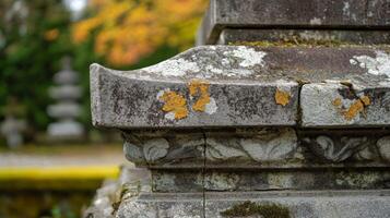 Closeup of an Ornate Stone Structure with Yellow Lichen photo