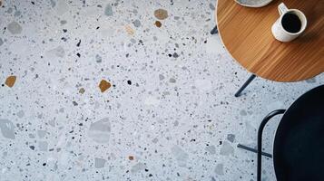 A Cup of Coffee on a Round Table with a Terrazzo Floor photo