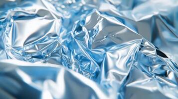 Abstract Close-Up of Wrinkled Silver Foil with Blue Hues photo
