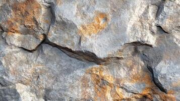 A Close-Up View of Rough, Grey Rock with Rusty Patches photo