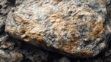 de cerca de un bruto, texturizado rock con gris, marrón, y amarillo parches foto