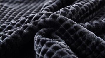 Close-up of a Soft, Black, Quilted Fabric with a Textured Pattern photo