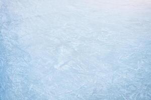 Icy background on rink with visible traces of skating from top view photo