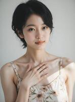 Graceful East Asian Woman in Beige Camisole, Delicate Studio Portrait photo