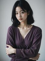 Graceful East Asian Model in Purple Wrap Top, Intimate Indoor Portrait photo