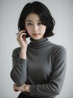 Pensive East Asian Woman in Dark Turtleneck, Studio Portrait with Gentle Pose photo