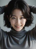 Joyful East Asian Woman in Dark Top, Expressive Studio Portrait photo