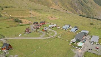 Stepantsminda, Georgia - 10th september, 2024 - aerial view mix of various luxury cottage houses surrounded with greenery in caucasus mountains video
